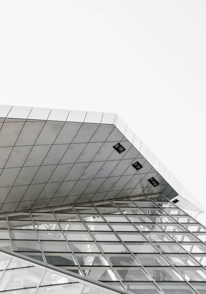 A vertical grey scale shot of a geometrical structure captured from a low angle